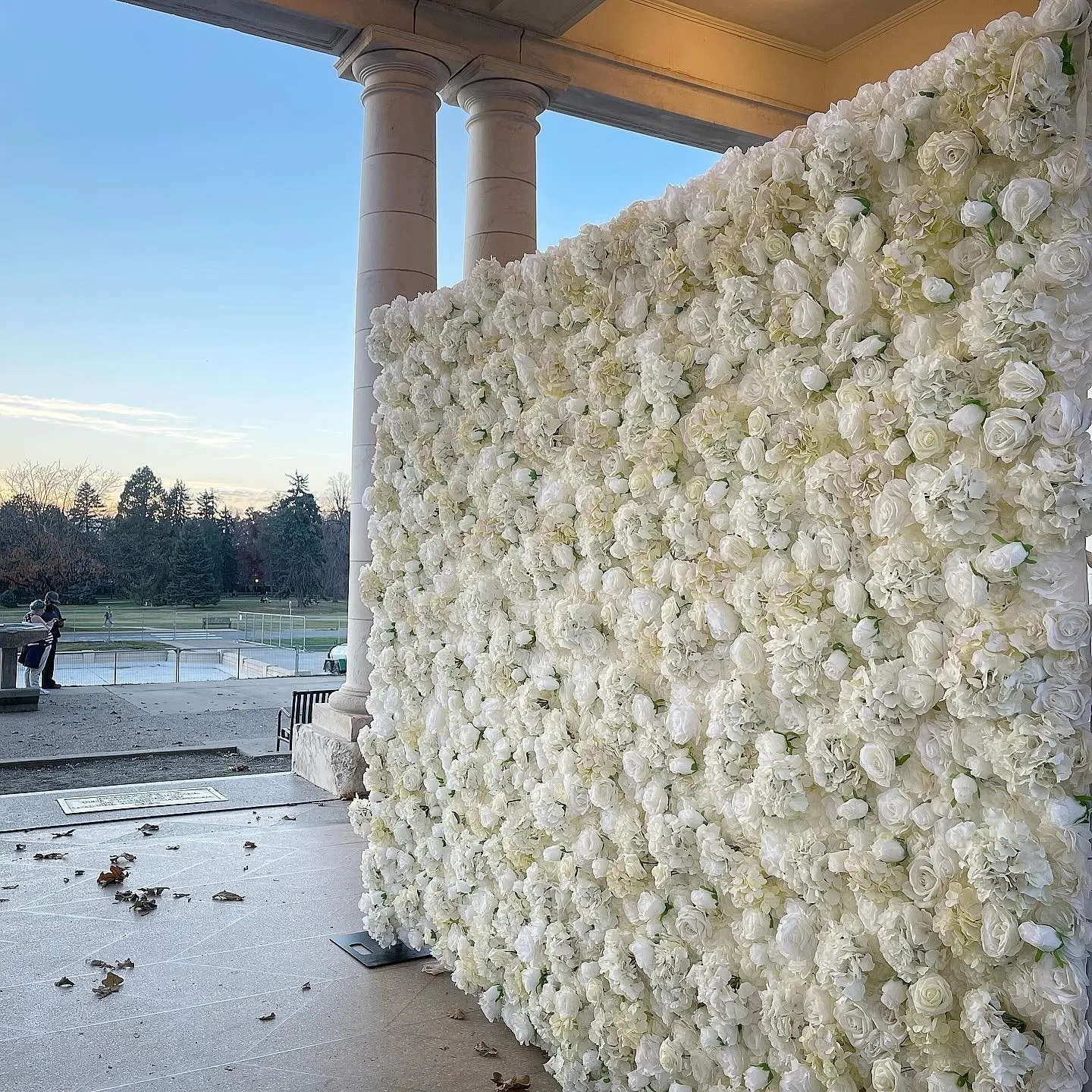 Edge of the flower wall with a Denver sunset behind it
